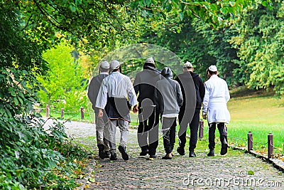 Older Hasidic Jews walk in the park during the Jewish New Year in Uman, Ukraine. Religious Jew Editorial Stock Photo