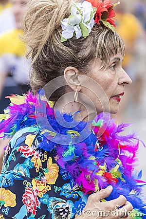 2018: Older lady wearing colorful feathers attending Gay Pride parade also known as Christopher Street Day CSD in Munich Editorial Stock Photo