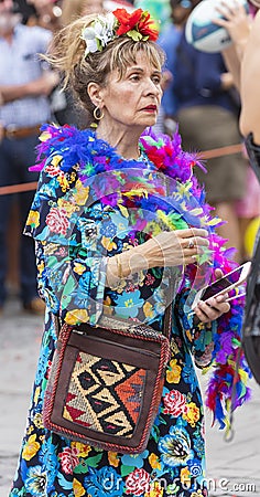 2018: Older lady wearing colorful feathers attending Gay Pride parade also known as Christopher Street Day CSD in Munich Editorial Stock Photo