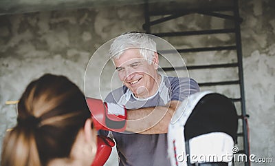 Older man boxing in gym. Stock Photo