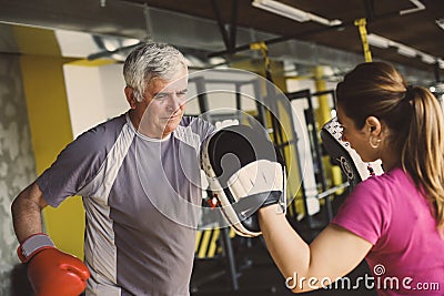 Older man boxing in gym. Stock Photo