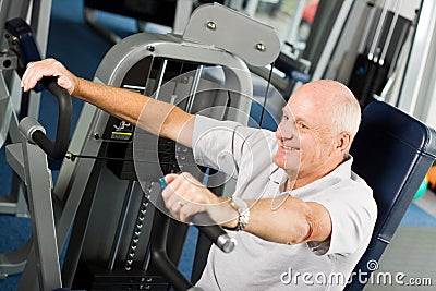 Older man exercising at the gym Stock Photo