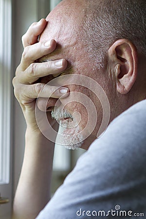 Older man expressing pain or depression, vertical Stock Photo