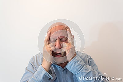 Older man hands to temples in pain, bald, alopecia, chemotherapy, cancer, isolated on white Stock Photo