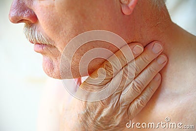 Senior man has hand on throat Stock Photo