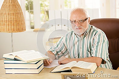 Older man working at his study Stock Photo