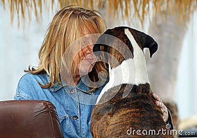 Older mature woman and her best friend dog hugging & talking Stock Photo