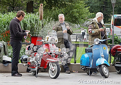 Older men dressed as mods posing at their retro vespa scooters Editorial Stock Photo