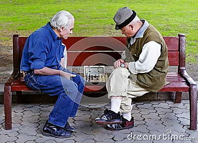 Older people play chess on a bench Editorial Stock Photo