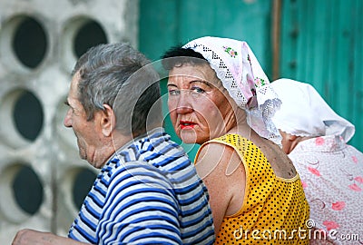 Older people: three Russian pensioners on a bench near the entrance of an apartment building Editorial Stock Photo