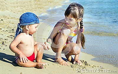 The older sister and younger brother on the seashore look at each other, Stock Photo