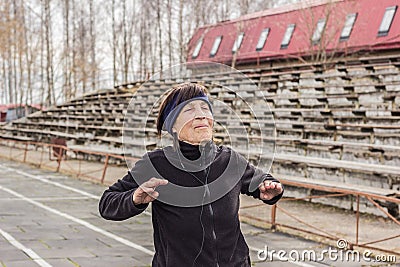 Older woman doing outdoor exercise. Stock Photo