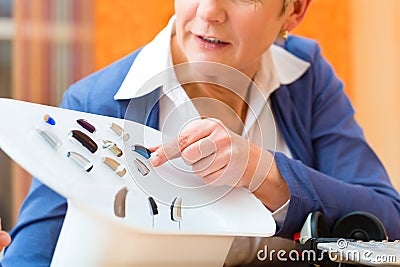 Deaf woman with hearing aid Stock Photo