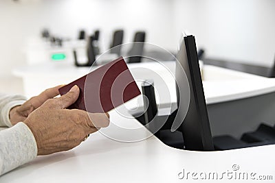 Older woman wait passport check in airport Stock Photo