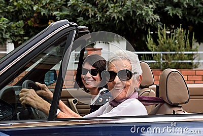 older woman and a young woman driving a convertible Stock Photo