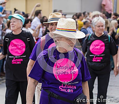 Older women wearing Tshirts `Sappho goes 60` attending the Gay Pride parade also known as Christopher Street Day CSD in Munich Editorial Stock Photo