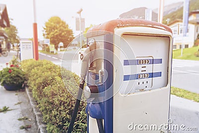 Oldtime or vintage Red white blue color fuel gasoline station box and dispenser in blur Europe background. S Stock Photo