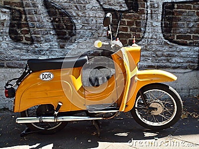 Oldtimer motor scooter of the historic DDR, Germany, in front of a wall Editorial Stock Photo