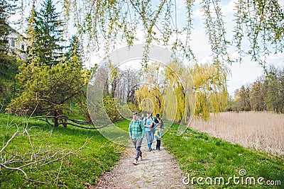 OLESKO, UKRAINE - April 20, 2019: young group of people with kids walking by nature park Editorial Stock Photo