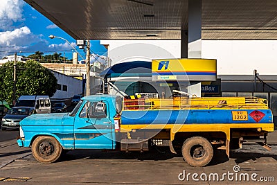 Tanker truck fills the reservoirs with fuel at a gas station belonging to the Ipiranga chain Editorial Stock Photo