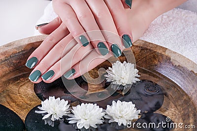 Green Olive Gel Nails: Serene Beauty Above Water Stock Photo