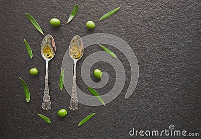 Olive oil in vintage spoons Stock Photo