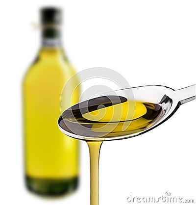 Olive oiled poured from a spoon Stock Photo