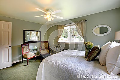 Olive tones bedroom with antique iron frame bed Stock Photo