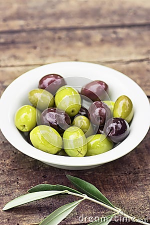 Olives and olive branches on a wooden rustic background. Rustic still life Stock Photo