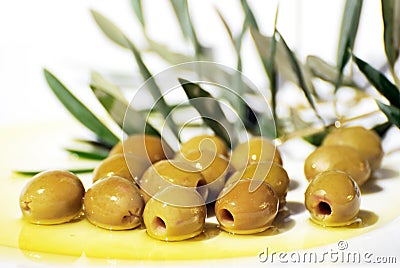 Olives and Olive Oil on plate Stock Photo
