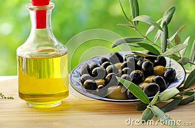 Olives on plate and oliveoil Stock Photo