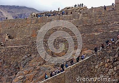 Ollantaytambo/Peru - Oct.02.19: tourists climbing the stairs of archaeological park, on the Sacred valley of incas Editorial Stock Photo