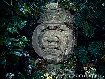 Olmec sculpture carved from stone. Big stone head statue in a jungle Stock Photo