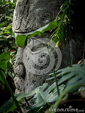Olmec sculpture carved from stone. Mayan symbol - Big stone head statue in a jungle Stock Photo