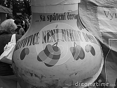 Retro image - Close-up view on a giant plum brandy bottle with funny writing at Flora Exposition at local market Editorial Stock Photo