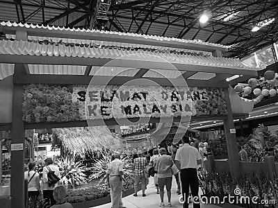 Retro image - Red Gateway at the entrance of Malay themed Flora Exposition with gladiola flowers and tourists. Editorial Stock Photo