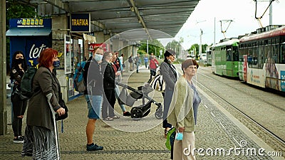 OLOMOUC, CZECH REPUBLIC, JUNE 22, 2020: Coronavirus mask face tram streetcar stop tram crowd people passengers they get Editorial Stock Photo