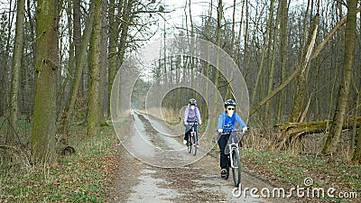 OLOMOUC, CZECH REPUBLIC, MARCH 13, 2020: Face masks coronavirus risk covid-19 family children on bike trip on bikes Editorial Stock Photo
