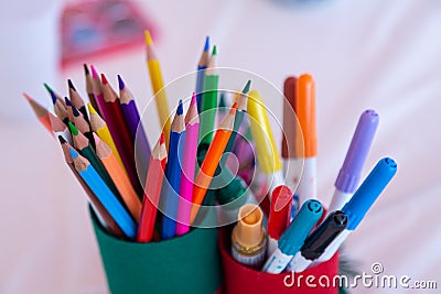 Ð¡olored pencils and felt-tip pens in a glass Stock Photo