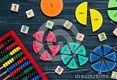 Ð¡olorful math fractions on dark wooden background or table. Interesting creative funny math for kids. Education, back to school Stock Photo