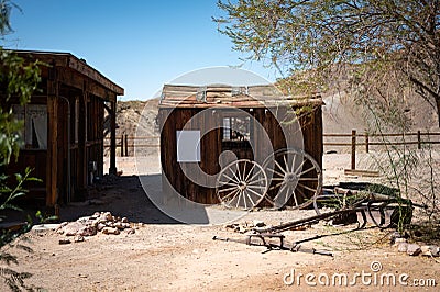 olshed with some wagon wheels leaning on it in the abandoned town of the far west Editorial Stock Photo