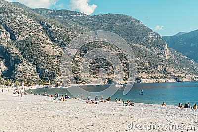 Oludeniz beach blue lagoon. Mediterranean beach in a Turkish resort with vacationing tourists. Summer, vacation, travel. Editorial Stock Photo