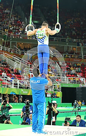 Olympic champion Eleftherios Petrounias of Greece competes at the Men`s Rings Final on artistic gymnastics competition at Rio Editorial Stock Photo