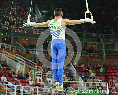 Olympic champion Eleftherios Petrounias of Greece competes at the Men`s Rings Final on artistic gymnastics competition at Rio Editorial Stock Photo