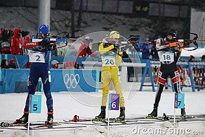 Olympic champion Martin Fourcade of France competes in the biathlon men`s 15km mass start at the 2018 Winter Olympics Editorial Stock Photo