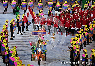 Olympic champion trampoline gymnast Rosie MacLennan carrying Canadian flag leading the Olympic team Canada in the Rio 2016 Opening Editorial Stock Photo