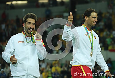 Olympic champions Mark Lopez and Rafael Nadal of Spain during medal ceremony after victory at men's doubles final Editorial Stock Photo