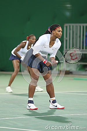 Olympic champions Serena and Venus Williams of USA in action during doubles first round match of the Rio 2016 Olympic Games Editorial Stock Photo