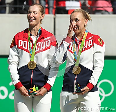 Olympic champions team Russia Ekaterina Makarova (L) and Elena Vesnina during medal ceremony after tennis doubles final Editorial Stock Photo