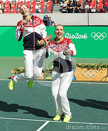 Olympic champions team Russia Ekaterina Makarova (L) and Elena Vesnina during medal ceremony after tennis doubles final Editorial Stock Photo
